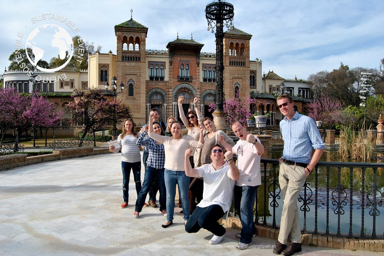 Corporate team ready to start the En Busca del Tesoro adventure at Plaza de América in Seville on a spring day