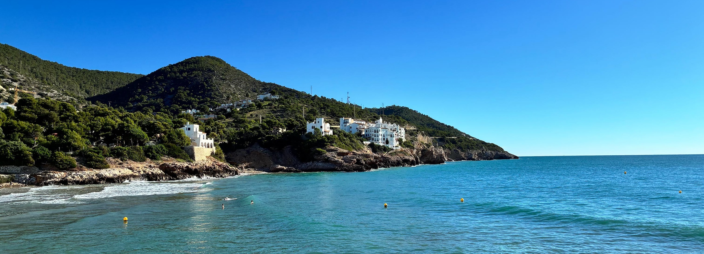 Panoramic view of La Marina beach and the skyline beside Port d'Aiguadolç in Sitges on a sunny autumn day.